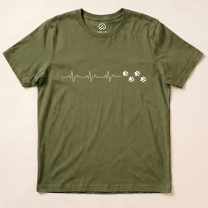 A flat olive green graphic t-shirt featuring a heartbeat line and paw prints, labeled as the "Heart Beat Faws Shirt.