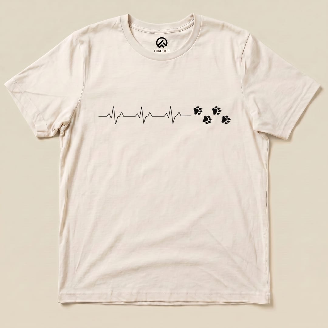 A graphic t-shirt featuring the "Heart Beat Faws Shirt" design, displaying a heartbeat line accompanied by paw prints.