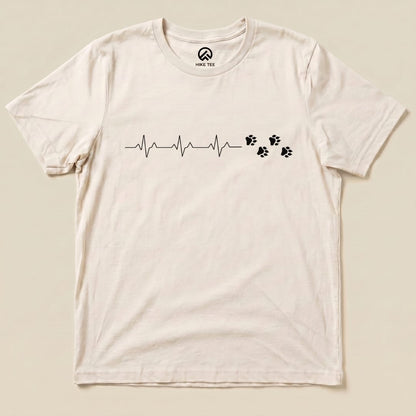 A graphic t-shirt featuring the "Heart Beat Faws Shirt" design, displaying a heartbeat line accompanied by paw prints.