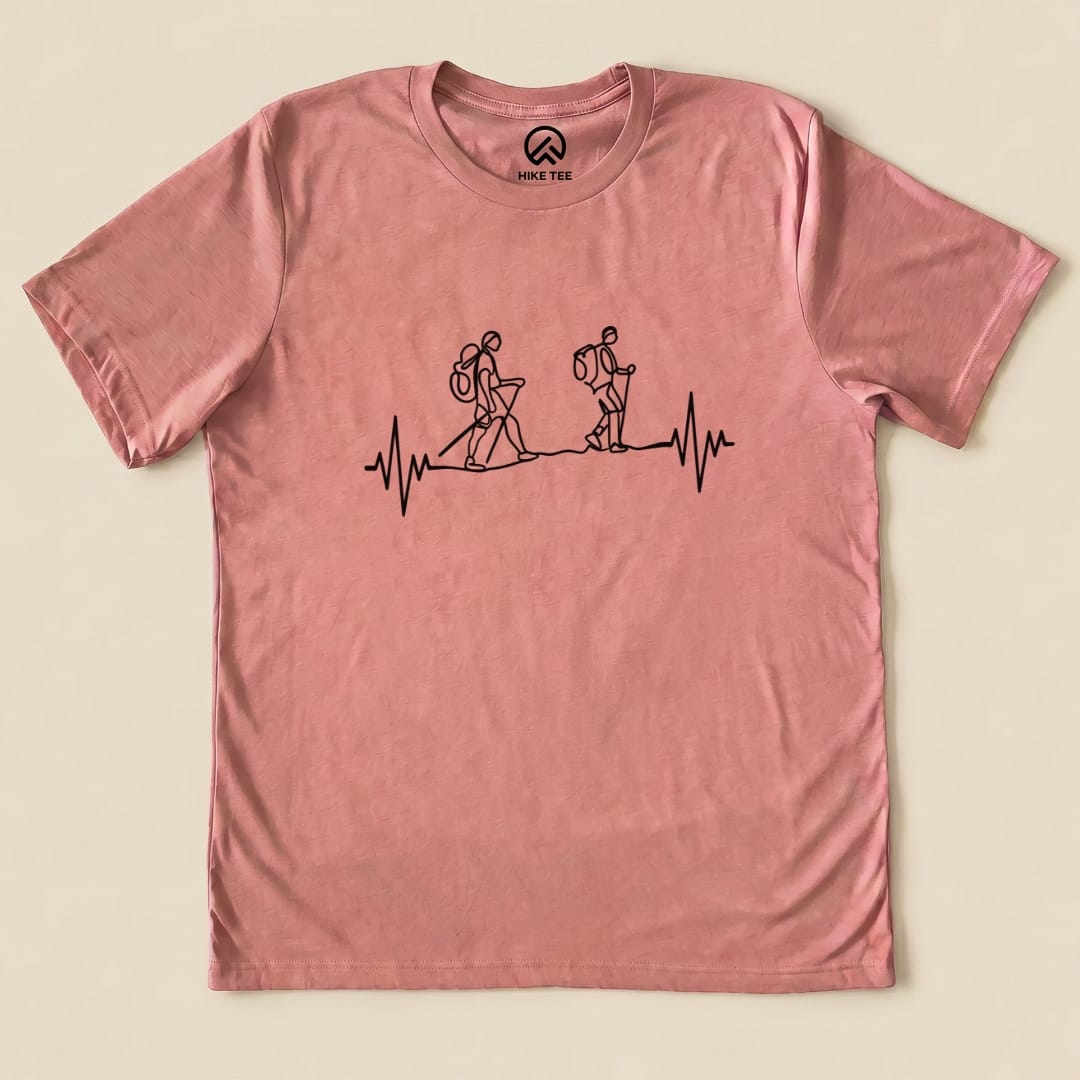 A graphic t-shirt featuring two hikers walking on a heartbeat line, labeled as the "Heart Rate Hiking Shirt.