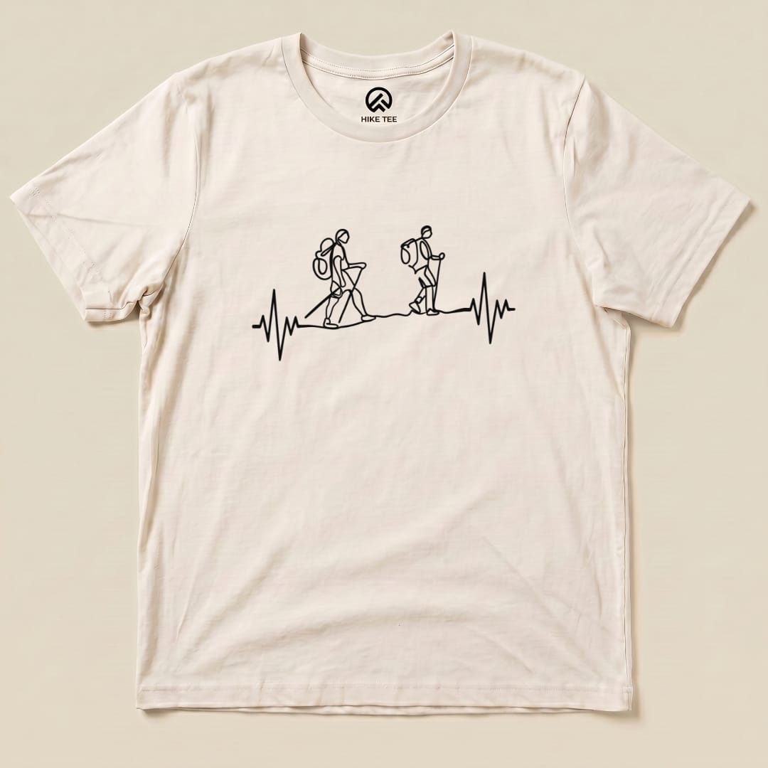 A graphic t-shirt featuring line-art hikers and a heartbeat symbol, representing the "Heart Rate Hiking Shirt" design.