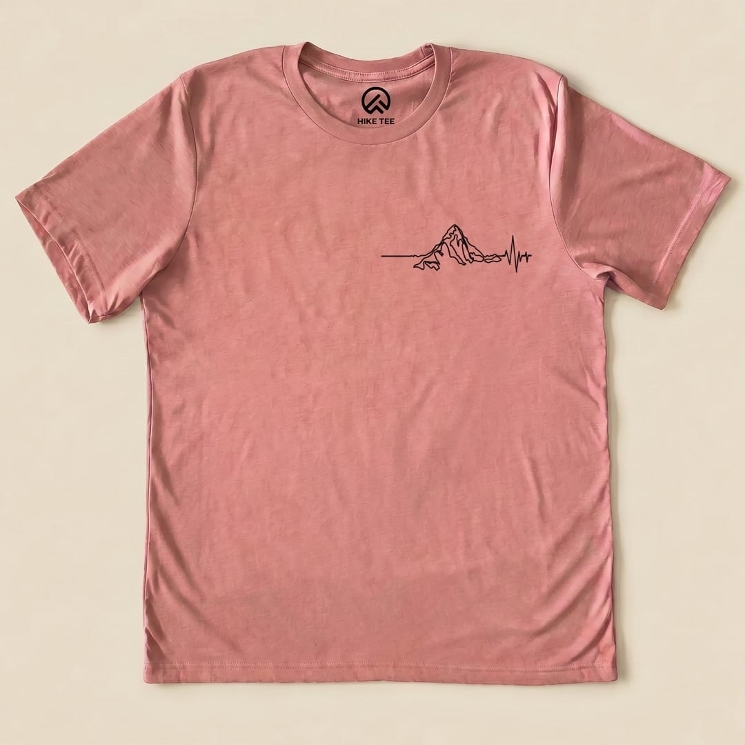 The graphic t-shirt features a minimalist mountain design with an EKG heartbeat line, representing the "Heart Rate Mountain Shirt.