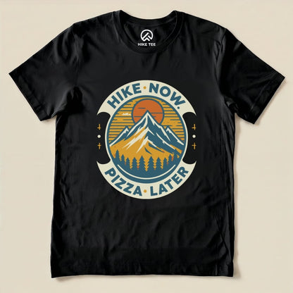 Graphic t-shirt featuring the slogan "Hike Now Pizza Later" with mountains and trees, perfect for outdoor enthusiasts.