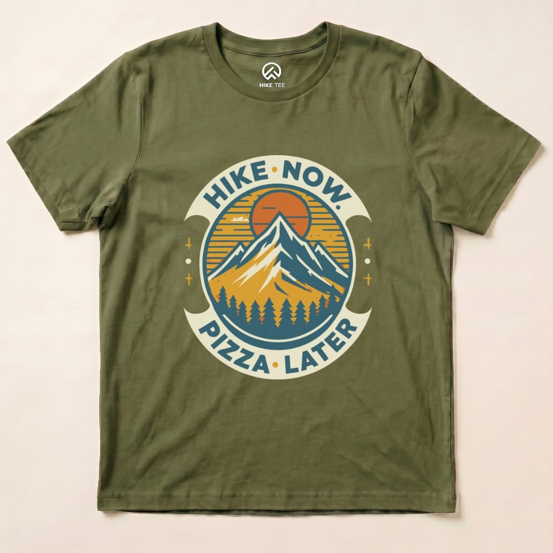 Graphic t-shirt featuring a mountain scene with the slogan "Hike Now Pizza Later" in a fun, colorful design.