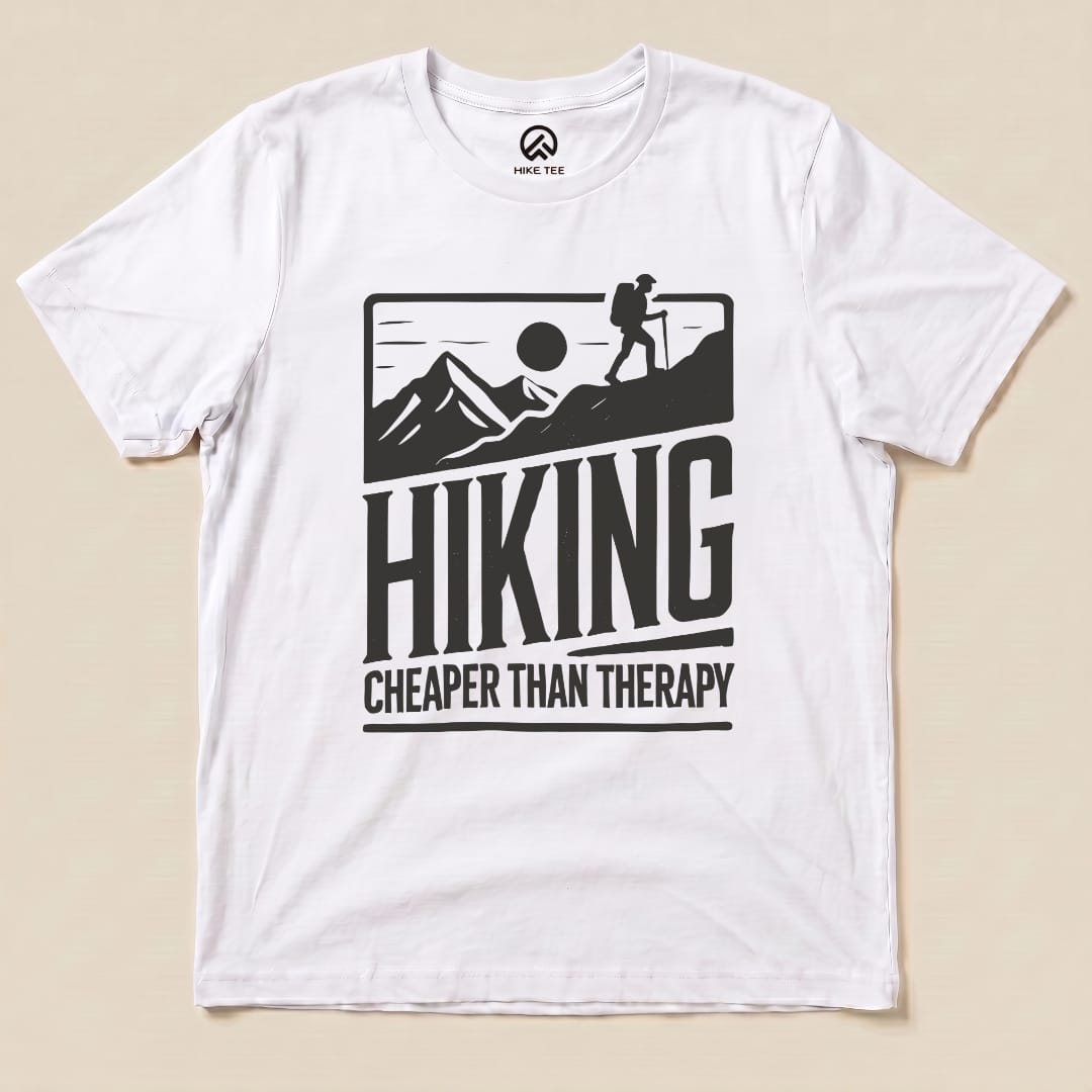 The graphic t-shirt features the slogan "Hiking Cheaper Than Therapy" alongside a hiker silhouette against a mountain backdrop.