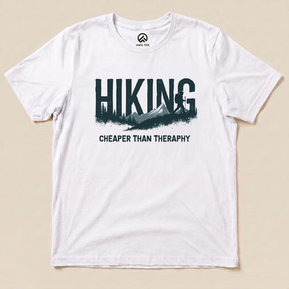 Graphic t-shirt from Hike Tee featuring the phrase "Hiking - Cheaper than Therapy" with a mountain and tree design.