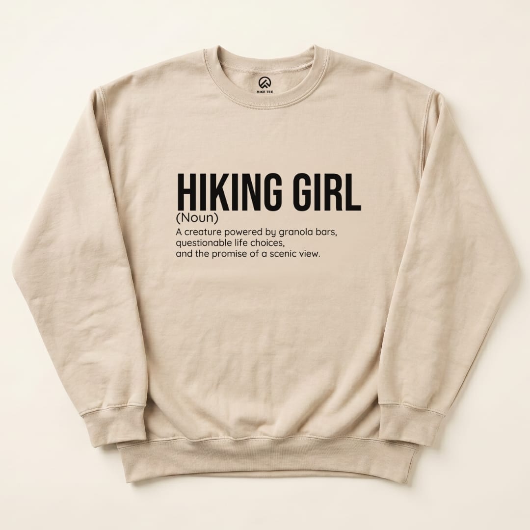 A beige "Hiking Girl Definition Sweatshirt" featuring humorous text defining a hiking girl and her traits.