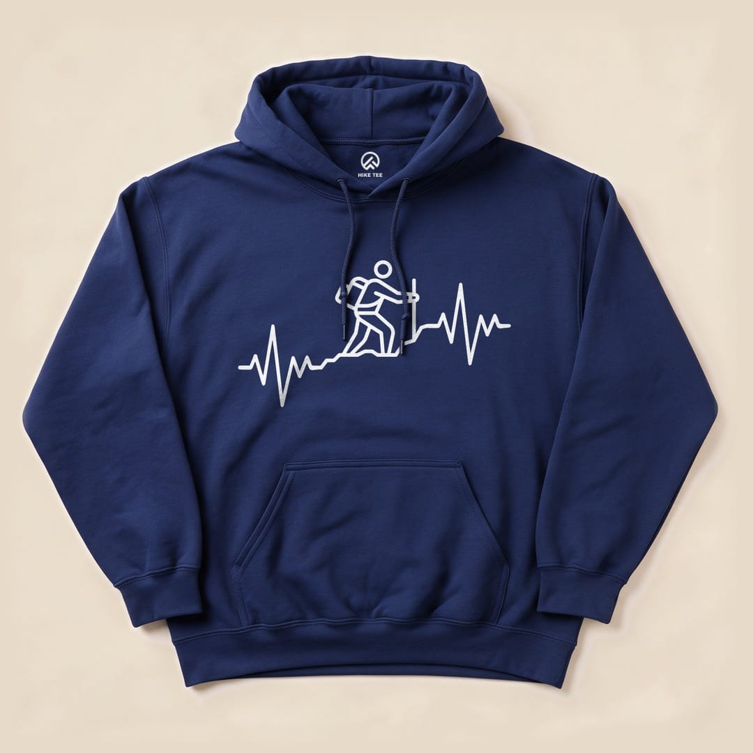 Navy blue "Hiking Heart Rate Hoodie" featuring a white graphic of a hiker on a heartbeat line, designed for outdoor enthusiasts.