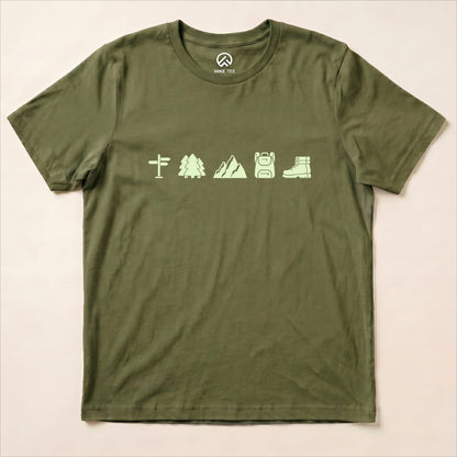 A flat lay of a green graphic t-shirt featuring hiking icons including a signpost, trees, mountains, backpack, and boots, labeled as "Hiking Mini Shirt.