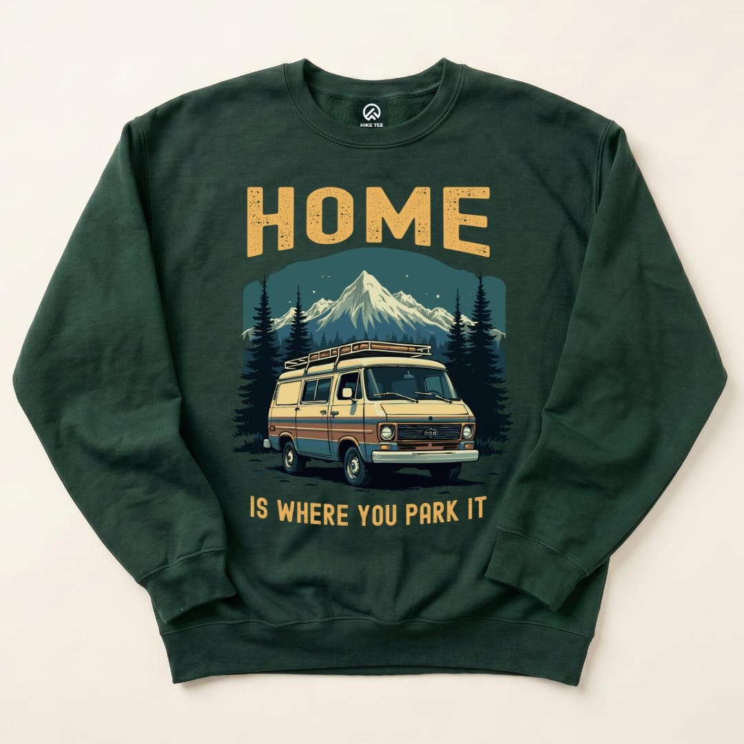 The Home Parked Sweatshirt features a vintage van graphic with the slogan "HOME IS WHERE YOU PARK IT" surrounded by mountains.