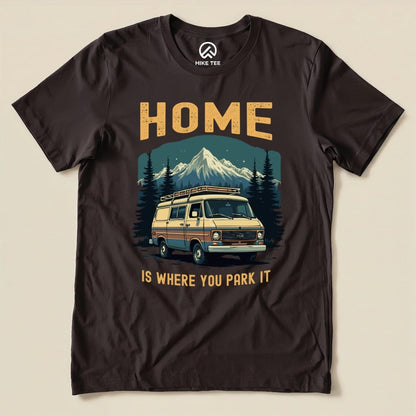 A graphic t-shirt featuring a vintage van, mountains, and the slogan "HOME IS WHERE YOU PARK IT," showcasing the Home You Park It Shirt design.