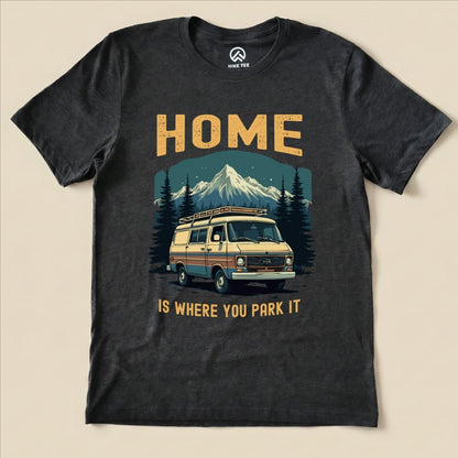 A graphic t-shirt featuring a vintage van and the slogan "HOME IS WHERE YOU PARK IT," labeled as the Home You Park It Shirt.