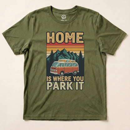 Graphic t-shirt featuring the design "HOME IS WHERE YOU PARK IT" with a vintage van, mountains, and trees in earthy tones.
