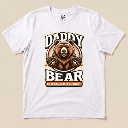 White graphic t-shirt featuring a bear illustration with the text "Daddy Bear" and "The Original Bear Hug Specialist" below.