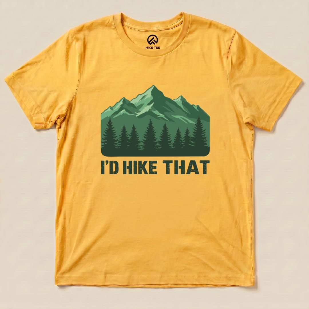 A yellow graphic t-shirt features a design with green mountains and trees along with the text "I'D HIKE THAT" prominently displayed.