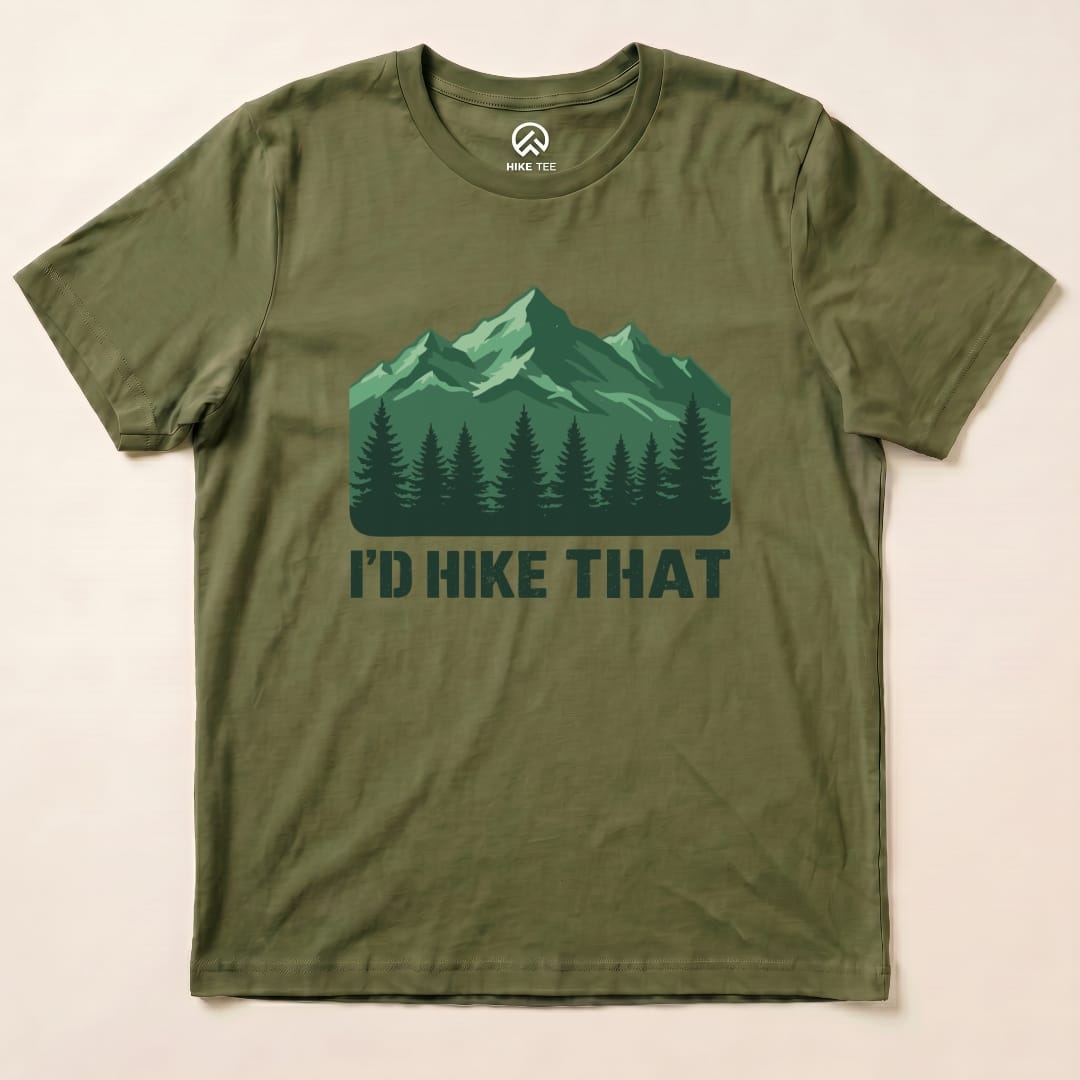 An olive green graphic t-shirt featuring a mountain landscape and the phrase "I'D HIKE THAT" beneath it.