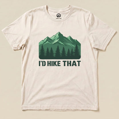 A cream graphic t-shirt features a green mountain design with the slogan "I'D HIKE THAT" printed below a tree line.