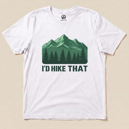 A white graphic t-shirt featuring a mountain landscape and the slogan "I'D HIKE THAT" in bold letters below.