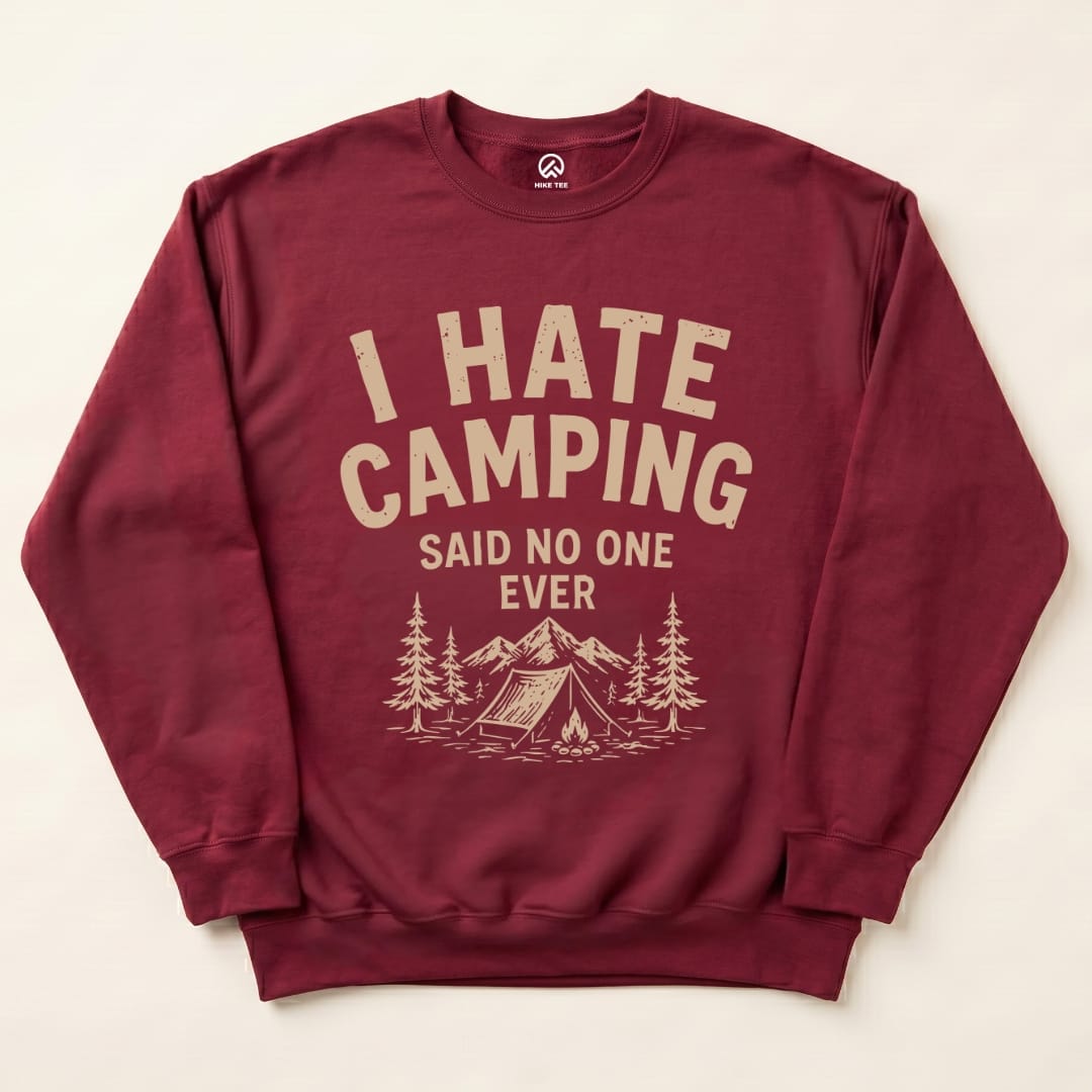 A maroon "I Hate Camping Sweatshirt" features bold text and a camp scene with trees and mountains in a humorous design.