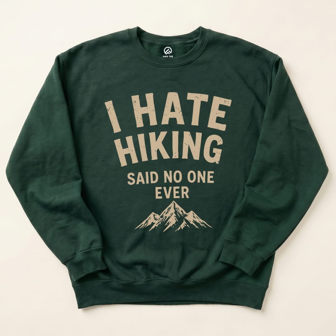 The dark green "I Hate Hiking Sweatshirt" features bold text that reads "I HATE HIKING" above "SAID NO ONE EVER," with a mountain graphic below.