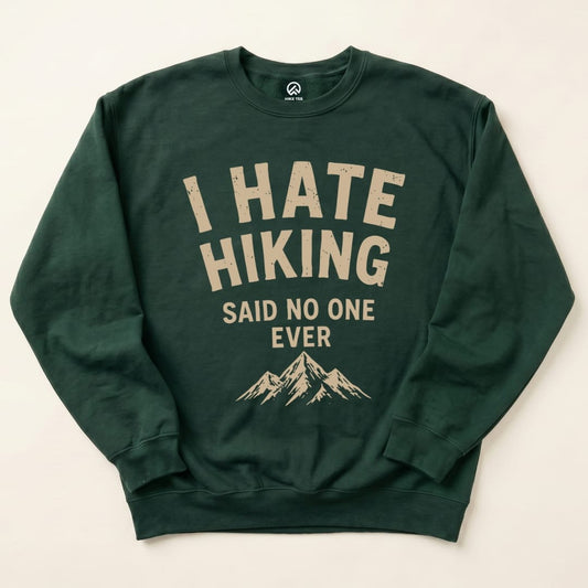 The dark green "I Hate Hiking Sweatshirt" features bold text that reads "I HATE HIKING" above "SAID NO ONE EVER," with a mountain graphic below.