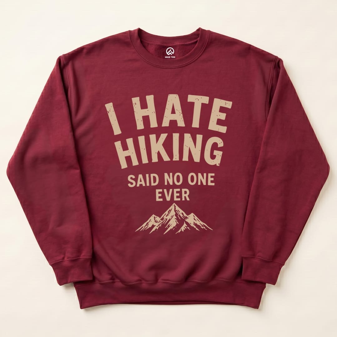 A maroon "I Hate Hiking Sweatshirt" featuring the slogan "I HATE HIKING SAID NO ONE EVER" above a mountain graphic.