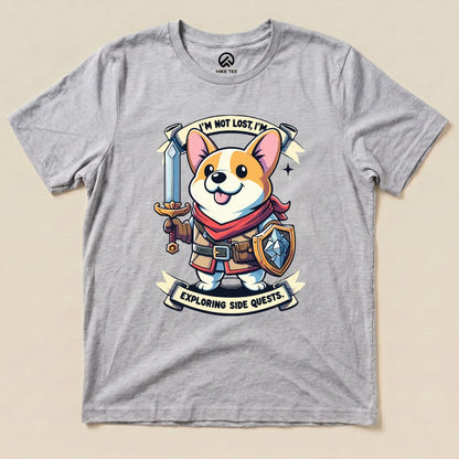 A graphic t-shirt featuring a cartoon corgi holding a sword and shield, with the caption "I'm Not Lost, I'm Exploring Side Quests.