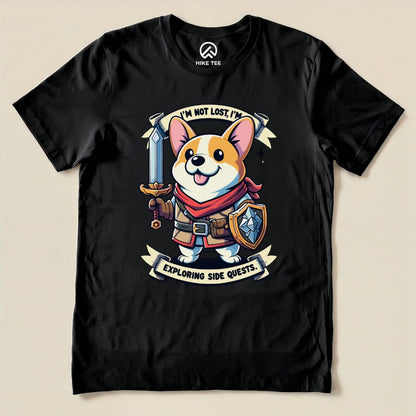 A graphic t-shirt featuring a cheerful corgi holding a sword and shield with the text "I'm Not Lost, I'm Exploring Side Quests.