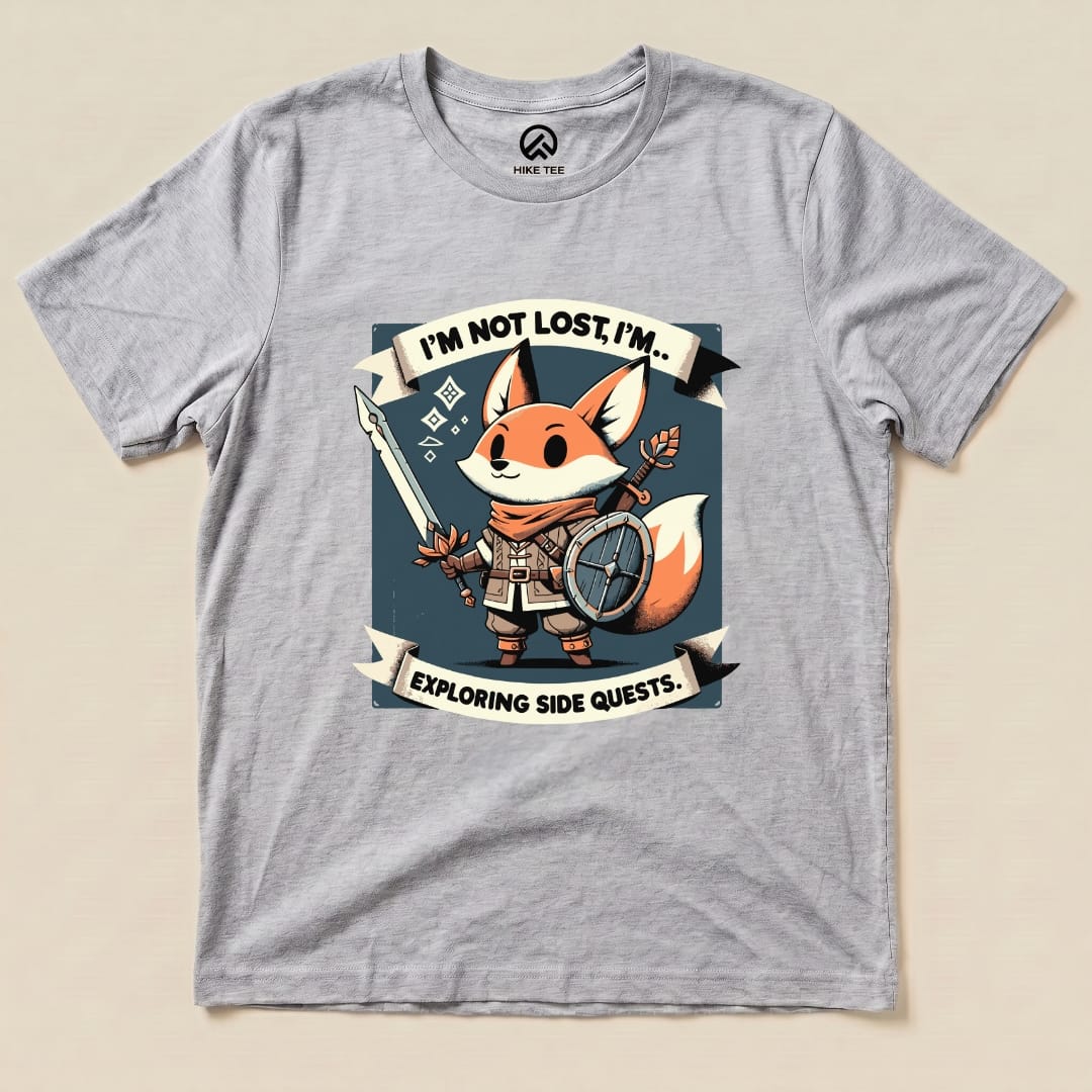 The graphic t-shirt features a cartoon fox holding a spear and shield, with the text "I'm Not Lost, I'm Exploring Side Quests" prominently displayed.