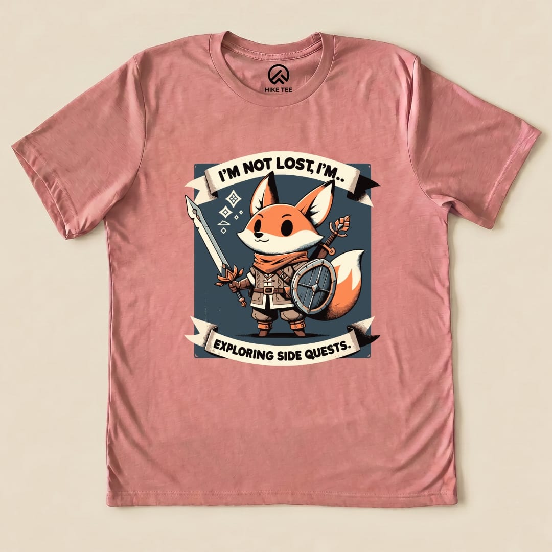 The "I'm Not Lost Fox Shirt" is a graphic t-shirt featuring a fox character holding a spear and shield with the slogan "I'M NOT LOST, I'M... EXPLORING SIDE QUESTS.