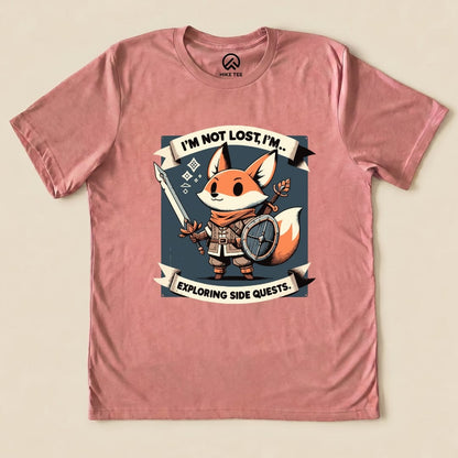 The "I'm Not Lost Fox Shirt" is a graphic t-shirt featuring a fox character holding a spear and shield with the slogan "I'M NOT LOST, I'M... EXPLORING SIDE QUESTS.