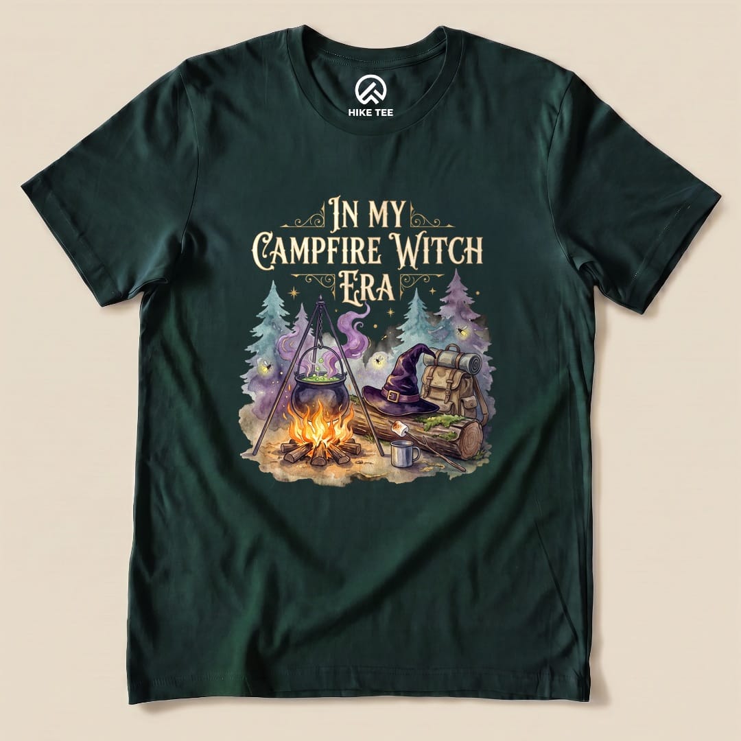 Forest In My Campfire Witch Era Shirt with a witch cauldron over a campfire with a witch hat and backpack graphic