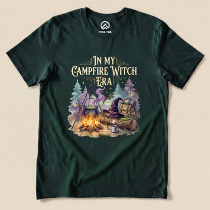 Forest In My Campfire Witch Era Shirt with a witch cauldron over a campfire with a witch hat and backpack graphic