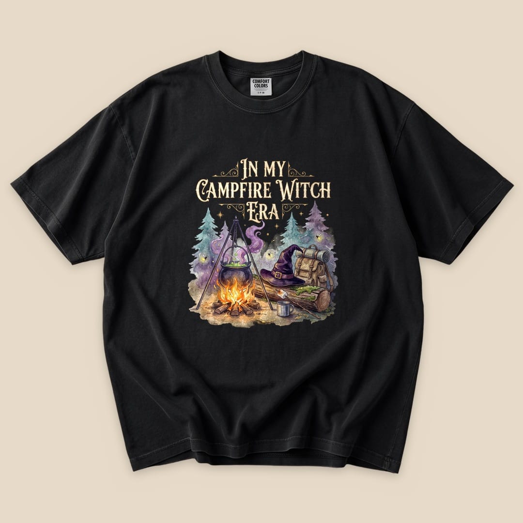 Black In My Campfire Witch Era T-Shirt with a witch cauldron over a campfire with a witch hat and backpack graphic
