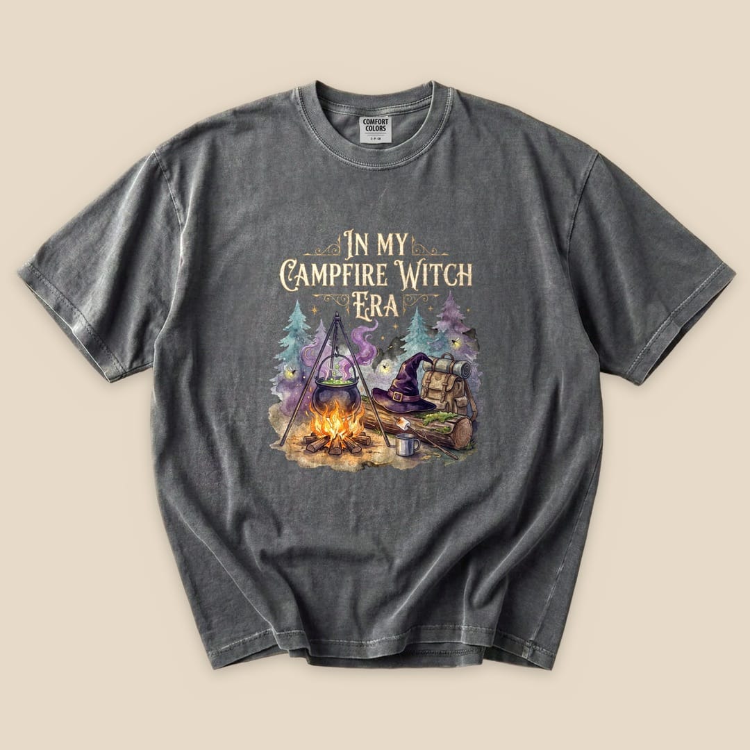 Pepper In My Campfire Witch Era T-Shirt with a witch cauldron over a campfire with a witch hat and backpack graphic