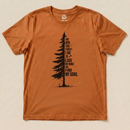 A flat graphic t-shirt in a warm orange shade featuring a tall tree illustration with the text "And into the forest I go to lose my mind and find my soul.