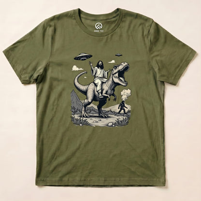 A graphic t-shirt featuring Jesus riding a T-rex, with Bigfoot in the background, and UFOs above in a whimsical design.