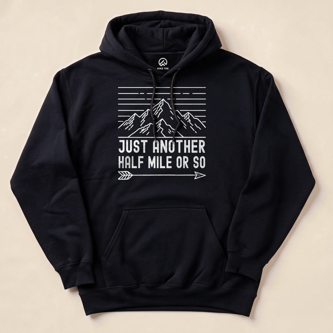 A black hoodie features the phrase "Just Another Half Mile Or So" alongside a graphic of mountains and an arrow design.