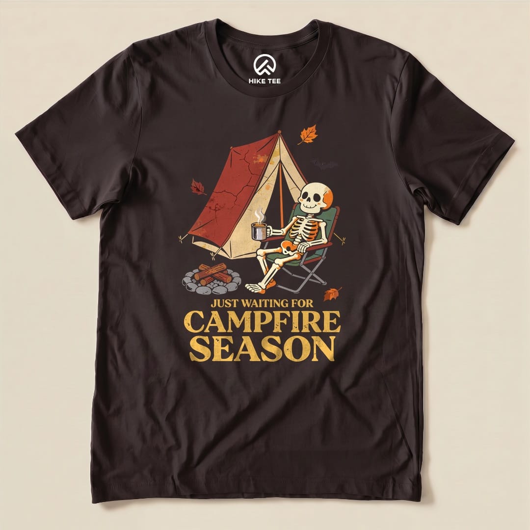 Brown Just Waiting for Campfire Season Shirt with a skeleton in a camp chair by a tent graphic