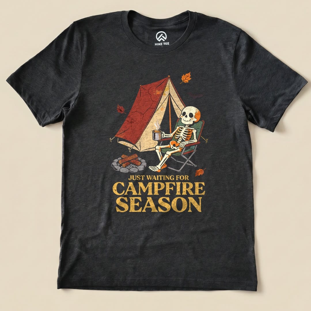Dark Grey Heather Just Waiting for Campfire Season Shirt with a skeleton in a camp chair by a tent graphic