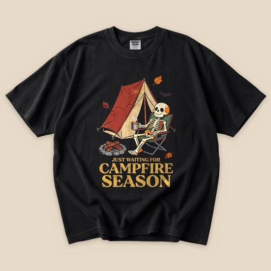 Black Just Waiting for Campfire Season T-Shirt with a skeleton in a camp chair by a tent graphic