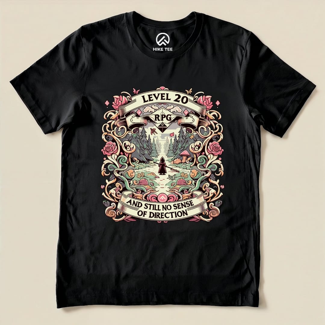 A black graphic t-shirt featuring the "Level 20 Sarcastic Shirt" design with the text "RPG" and "AND STILL NO SENSE OF DIRECTION" surrounded by whimsical floral patterns.