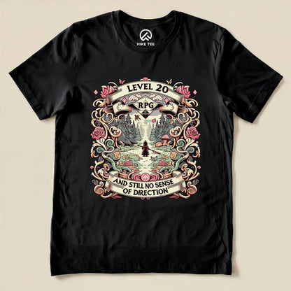 A black graphic t-shirt featuring the "Level 20 Sarcastic Shirt" design with the text "RPG" and "AND STILL NO SENSE OF DIRECTION" surrounded by whimsical floral patterns.