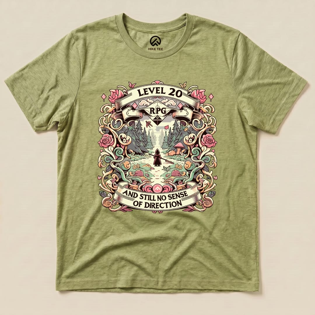 The graphic t-shirt features a colorful design with the text "Level 20 RPG AND STILL NO SENSE OF DIRECTION" surrounded by flowers and a scenic forest.