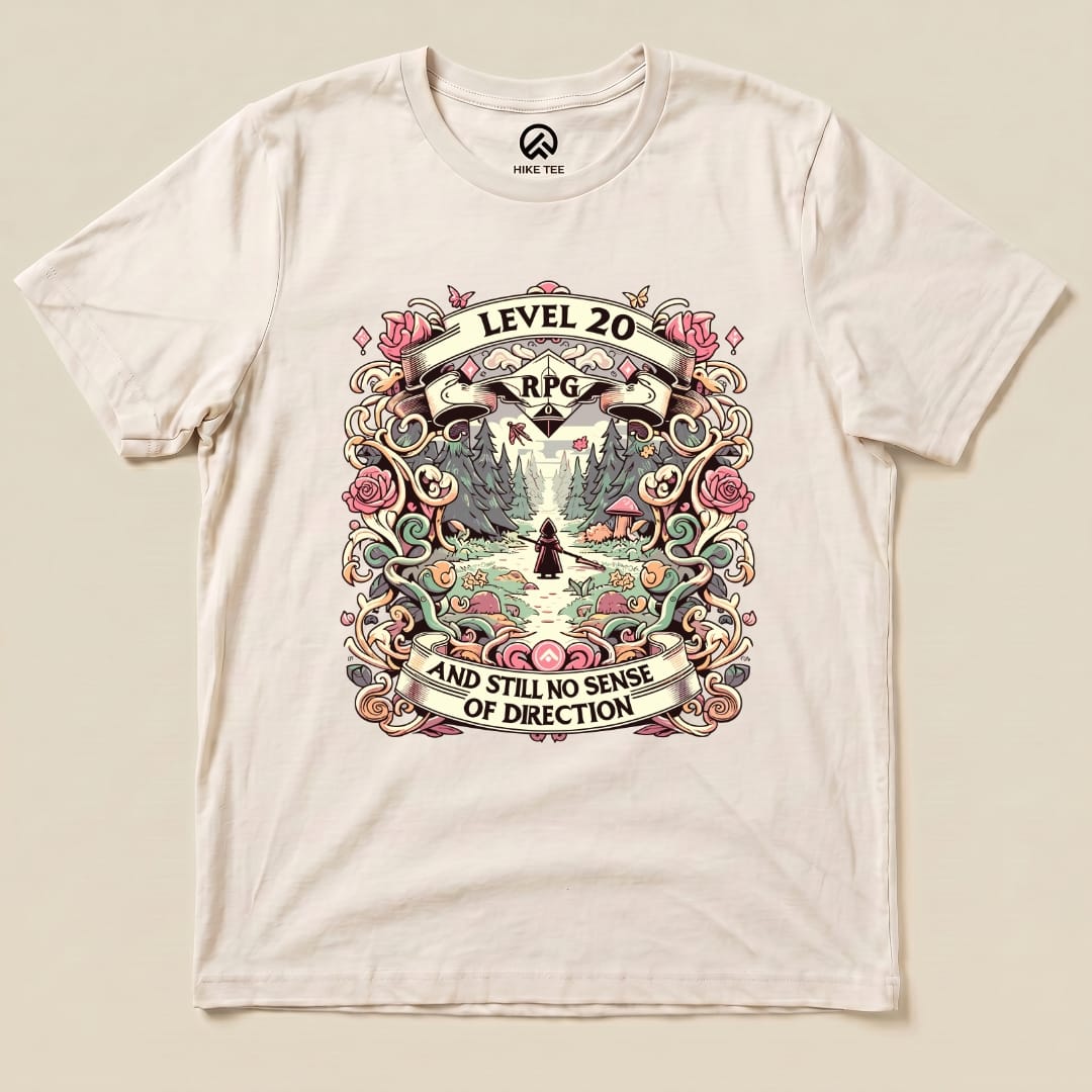 A flat graphic t-shirt featuring the "Level 20 Sarcastic Shirt" design with a whimsical landscape and the slogan "and still no sense of direction.