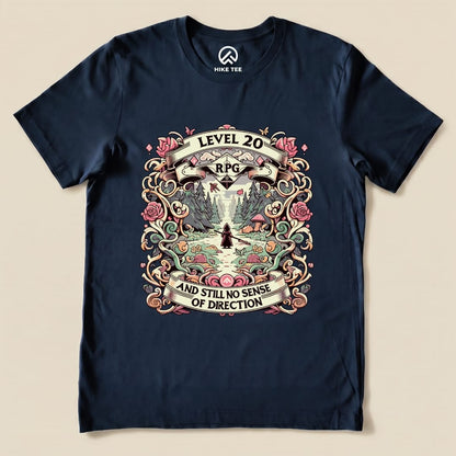 The graphic t-shirt displays a colorful design featuring the phrase "Level 20 RPG AND STILL NO SENSE OF DIRECTION" amidst a nature scene.