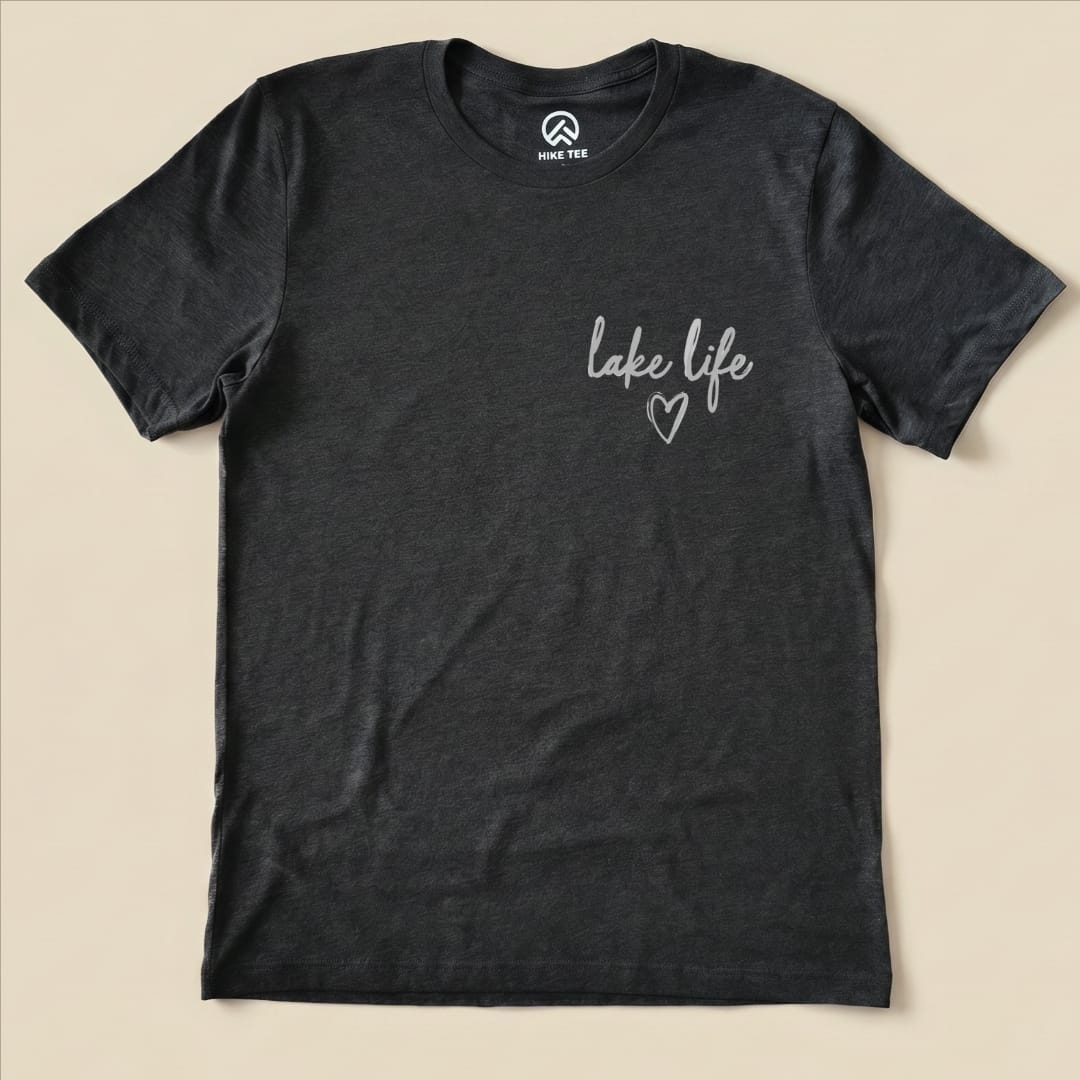 A charcoal graphic t-shirt features the phrase "lake life" with a heart symbol, representing the casual outdoor lifestyle.