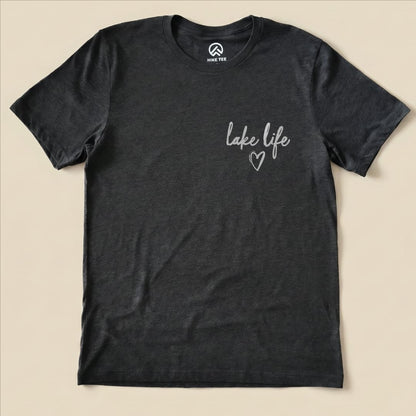 A charcoal graphic t-shirt features the phrase "lake life" with a heart symbol, representing the casual outdoor lifestyle.