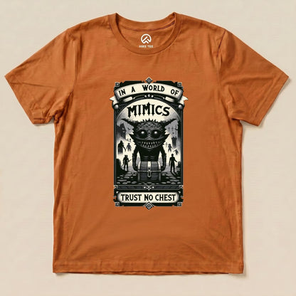 The orange graphic t-shirt features the "Mimics Shirt" design, showcasing a large monster with the slogan "In a World of Mimics, Trust No Chest.