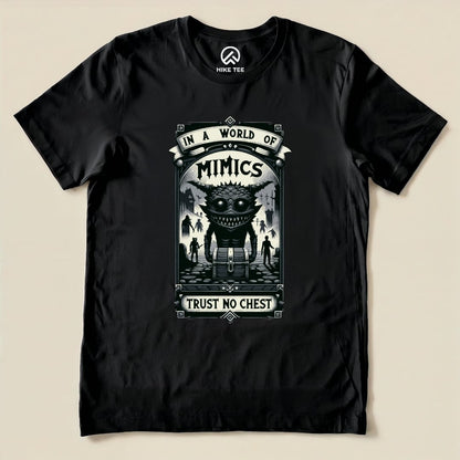 The graphic t-shirt features a whimsical design with the text "IN A WORLD OF MIMICS" and "TRUST NO CHEST" beneath a cartoonish creature.